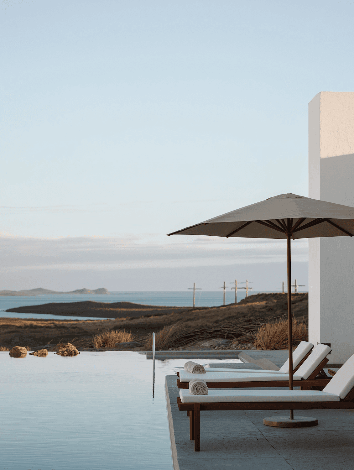 Infinity pool and sun loungers overlooking the coast