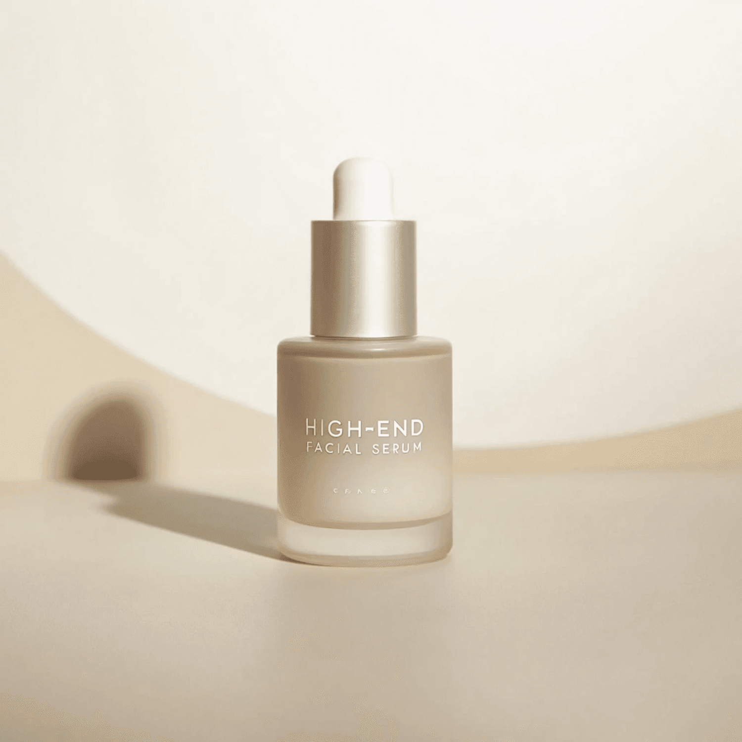 Frosted glass serum bottle on a warm beige set